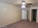 Bedroom with ceiling fan, neutral walls, carpet and doorway to walk in closet and bath at 7963 Laurena Ave, Las Vegas, NV 89147