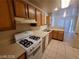 Functional kitchen featuring appliances, wooden cabinets, and lots of counter space at 7963 Laurena Ave, Las Vegas, NV 89147