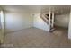 Open floor plan living room with tile floors and a staircase at 7963 Laurena Ave, Las Vegas, NV 89147