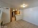 Open-concept dining and kitchen area with tile floors and neutral paint at 7963 Laurena Ave, Las Vegas, NV 89147