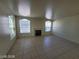 Spacious living room featuring tile floors, natural light, and a fireplace at 7963 Laurena Ave, Las Vegas, NV 89147