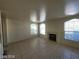 Bright living room features a fireplace, tile floors, and natural light at 7963 Laurena Ave, Las Vegas, NV 89147