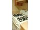 Close-up of a white Whirlpool gas range top with 4 burners and cream countertops at 7963 Laurena Ave, Las Vegas, NV 89147