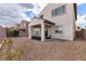 Backyard featuring gravel ground cover, covered patio, and a stucco house exterior at 8124 Loma Del Ray St, Las Vegas, NV 89131