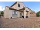 Exterior shot of a backyard with gravel landscaping, covered patio area and privacy wall at 8124 Loma Del Ray St, Las Vegas, NV 89131