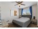 Cozy bedroom with a ceiling fan, plush carpet, and natural light at 8124 Loma Del Ray St, Las Vegas, NV 89131