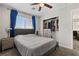 Comfortable bedroom featuring a queen-sized bed, ceiling fan, and a convenient closet space at 8124 Loma Del Ray St, Las Vegas, NV 89131