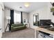 Bright room featuring desk, couch, window, and neutral colored carpet at 8124 Loma Del Ray St, Las Vegas, NV 89131