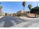 Street view of Greenfield community entrance, with signage, landscaped area and palm trees at 8124 Loma Del Ray St, Las Vegas, NV 89131