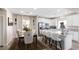 Open dining and kitchen area with modern white cabinets and breakfast bar seating at 8124 Loma Del Ray St, Las Vegas, NV 89131