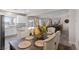 Inviting dining room with white cabinets, granite counters, stainless appliances, and views of the backyard at 8124 Loma Del Ray St, Las Vegas, NV 89131