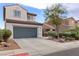 Exterior shot of a two-story home featuring a two-car garage, desert landscaping, and a neutral color scheme at 8124 Loma Del Ray St, Las Vegas, NV 89131