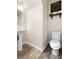 Simple half bath featuring a toilet, modern decor and wood-look flooring at 8124 Loma Del Ray St, Las Vegas, NV 89131