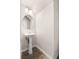 Elegant half-bathroom with pedestal sink, round mirror, and neutral walls at 8124 Loma Del Ray St, Las Vegas, NV 89131