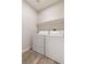 Bright laundry room includes a washer, dryer, and shelf at 8124 Loma Del Ray St, Las Vegas, NV 89131