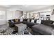 Spacious living room featuring neutral tones, a large sofa, and seamless flow to the kitchen and dining areas at 8124 Loma Del Ray St, Las Vegas, NV 89131