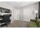 Well-lit office featuring a black pegboard organizer, modern desk setup, and access to closet and additional room at 8124 Loma Del Ray St, Las Vegas, NV 89131