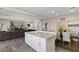 Open-concept living area with a kitchen island connecting to the dining and living spaces at 8124 Loma Del Ray St, Las Vegas, NV 89131
