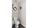 Modern half bath with updated toilet, sleek decor and wood-look flooring at 8124 Loma Del Ray St, Las Vegas, NV 89131