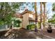 Backyard featuring mature palm trees and covered patio at 8169 Pinnacle Peak Ave, Las Vegas, NV 89113