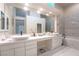 Large white bathroom with double sinks, vanity, and soaking tub at 8169 Pinnacle Peak Ave, Las Vegas, NV 89113