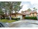 Inviting single-story home featuring a red tile roof, mature landscaping, and a convenient attached two-car garage at 8169 Pinnacle Peak Ave, Las Vegas, NV 89113