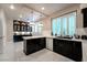 Modern kitchen with sleek black cabinets, white countertops, and stainless steel appliances, perfect for culinary enthusiasts at 8169 Pinnacle Peak Ave, Las Vegas, NV 89113