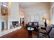Well-lit living room with a fireplace, hardwood floors, and inviting furnishings for relaxation and comfort at 8169 Pinnacle Peak Ave, Las Vegas, NV 89113