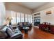 Comfortable living room featuring natural light, hardwood floors, and built-in shelving for personalized decor at 8169 Pinnacle Peak Ave, Las Vegas, NV 89113