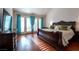 Bright main bedroom features hard wood floors, French doors with sunburst pattern and high ceiling at 8169 Pinnacle Peak Ave, Las Vegas, NV 89113