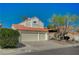 A two-story home with a two-car garage has a well-maintained lawn and desert landscaping at 8231 Wildfire St, Las Vegas, NV 89123