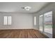 Bright living area with sliding glass doors to the backyard, wood floors, and natural light at 8231 Wildfire St, Las Vegas, NV 89123