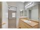 View of a bathroom with a sink vanity and doorway leading into a bedroom at 8250 N Grand Canyon Dr # 2059, Las Vegas, NV 89166