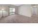 Bedroom with neutral carpet, sliding glass door to balcony and a view into hallway at 8250 N Grand Canyon Dr # 2059, Las Vegas, NV 89166