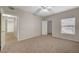 Spacious bedroom features plush carpeting, a ceiling fan, and a bright window at 8250 N Grand Canyon Dr # 2059, Las Vegas, NV 89166