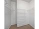Walk-in closet with carpeted floors and white shelving for organized storage at 8250 N Grand Canyon Dr # 2059, Las Vegas, NV 89166
