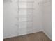 Walk in closet features carpeted floors and white wire shelving at 8250 N Grand Canyon Dr # 2059, Las Vegas, NV 89166