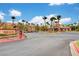 View of the entrance to the community with palm trees and a sign at 8250 N Grand Canyon Dr # 2059, Las Vegas, NV 89166