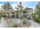 Inviting condominium with mature trees, desert landscaping and exterior stair access to upper units at 8250 N Grand Canyon Dr # 2059, Las Vegas, NV 89166