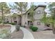 Inviting condominium with mature trees, desert landscaping and exterior stair access to upper units at 8250 N Grand Canyon Dr # 2059, Las Vegas, NV 89166