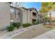 View of the condominium building showcasing landscaping and balcony access to upper units at 8250 N Grand Canyon Dr # 2059, Las Vegas, NV 89166
