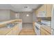 Fully equipped kitchen with a breakfast bar and stainless steel sink overlooking the dining area at 8250 N Grand Canyon Dr # 2059, Las Vegas, NV 89166