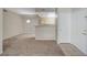 Open living space with neutral carpet and views into adjacent dining and kitchen area at 8250 N Grand Canyon Dr # 2059, Las Vegas, NV 89166
