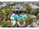 View of the community pool surrounded by palm trees and chairs at 8250 N Grand Canyon Dr # 2059, Las Vegas, NV 89166