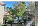 Resort-style pool area surrounded by palm trees and lush greenery at 8250 N Grand Canyon Dr # 2059, Las Vegas, NV 89166
