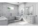 Bathroom with frameless shower, soaking tub, double vanity, marble tile surround and modern fixtures at 8825-1 S Monte Cristo Way, Las Vegas, NV 89113