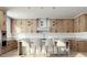 Well-lit kitchen boasting wood cabinetry, stainless steel appliances, sleek countertops, and a modern island with seating at 8825-1 S Monte Cristo Way, Las Vegas, NV 89113