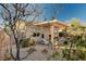 Cozy backyard with a covered patio, modern outdoor furniture, and scenic landscaping at 8856 Timber Mesa St, Las Vegas, NV 89139