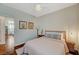 Bedroom features hard wood floors, ceiling fan, modern lamp, and decor on the walls at 8856 Timber Mesa St, Las Vegas, NV 89139