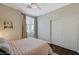 Bedroom featuring hard wood floors, slider door closet, ceiling fan, and bright window at 8856 Timber Mesa St, Las Vegas, NV 89139
